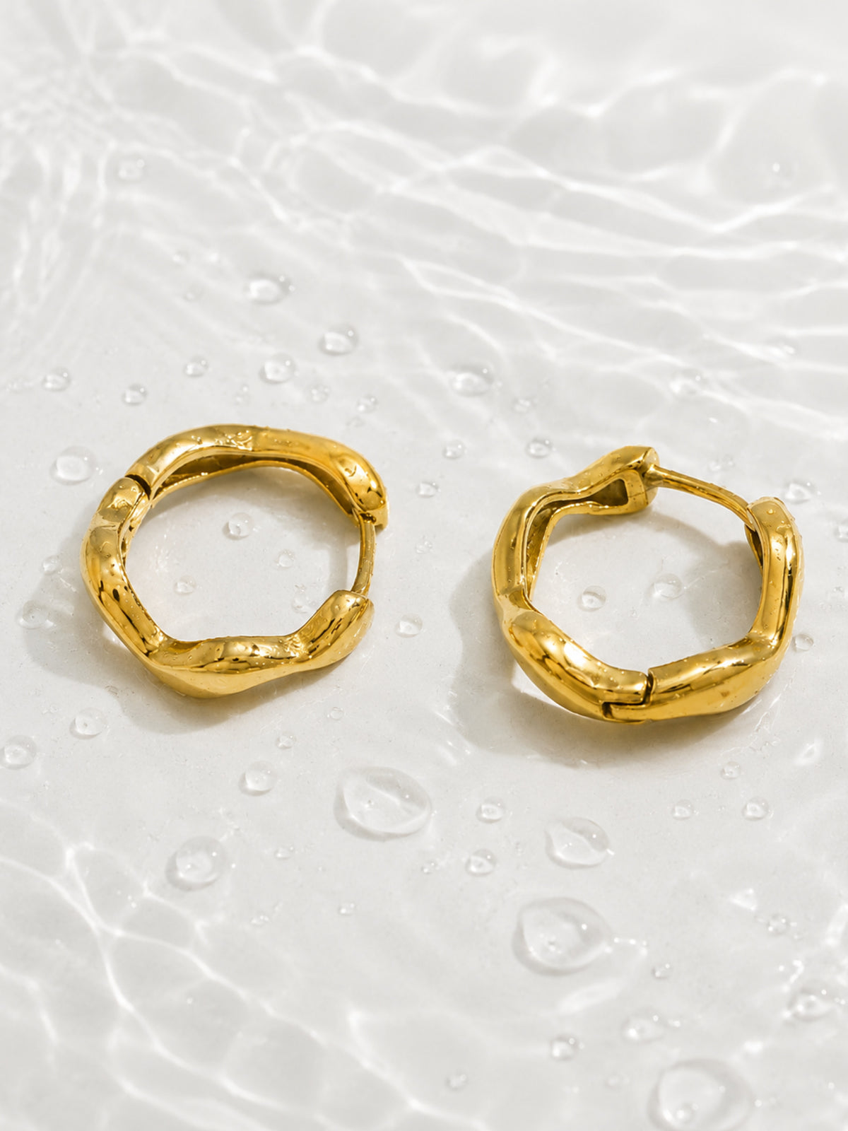 Nola Organic Wave Hoops in Gold showing the curved irregular wave design