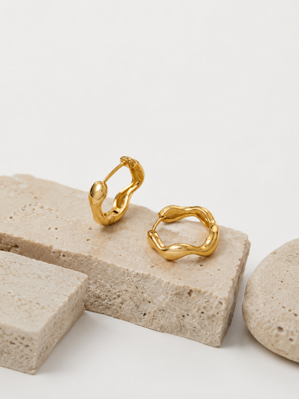 Close-up of the Nola Organic Wave Hoops showing the sculptural wave silhouette
