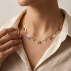 Close up of woman wearing gold Nyx abalone moon necklace celestial boho jewelry.