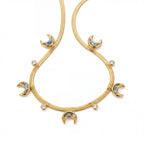 Close up detail of gold textured snake chain necklace with iridescent abalone shell crescent moon charms.
