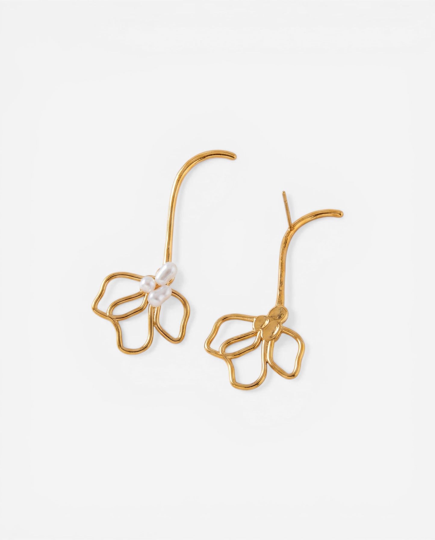 Gold long curved stem earrings with hollow petal shape and simulated pearls on white background.
