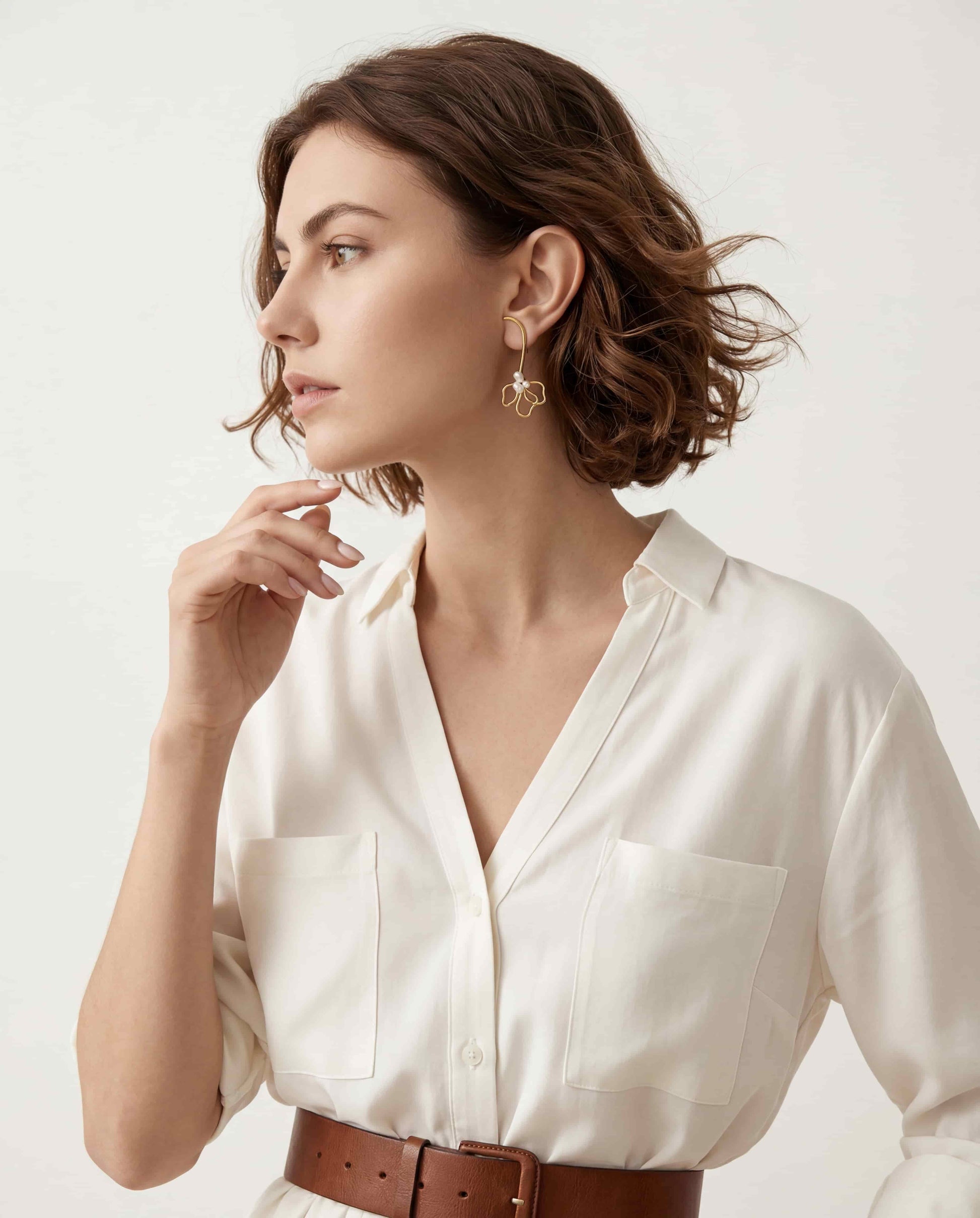 Elegant woman styling statement wire flower earrings French chic aesthetic everyday jewelry.