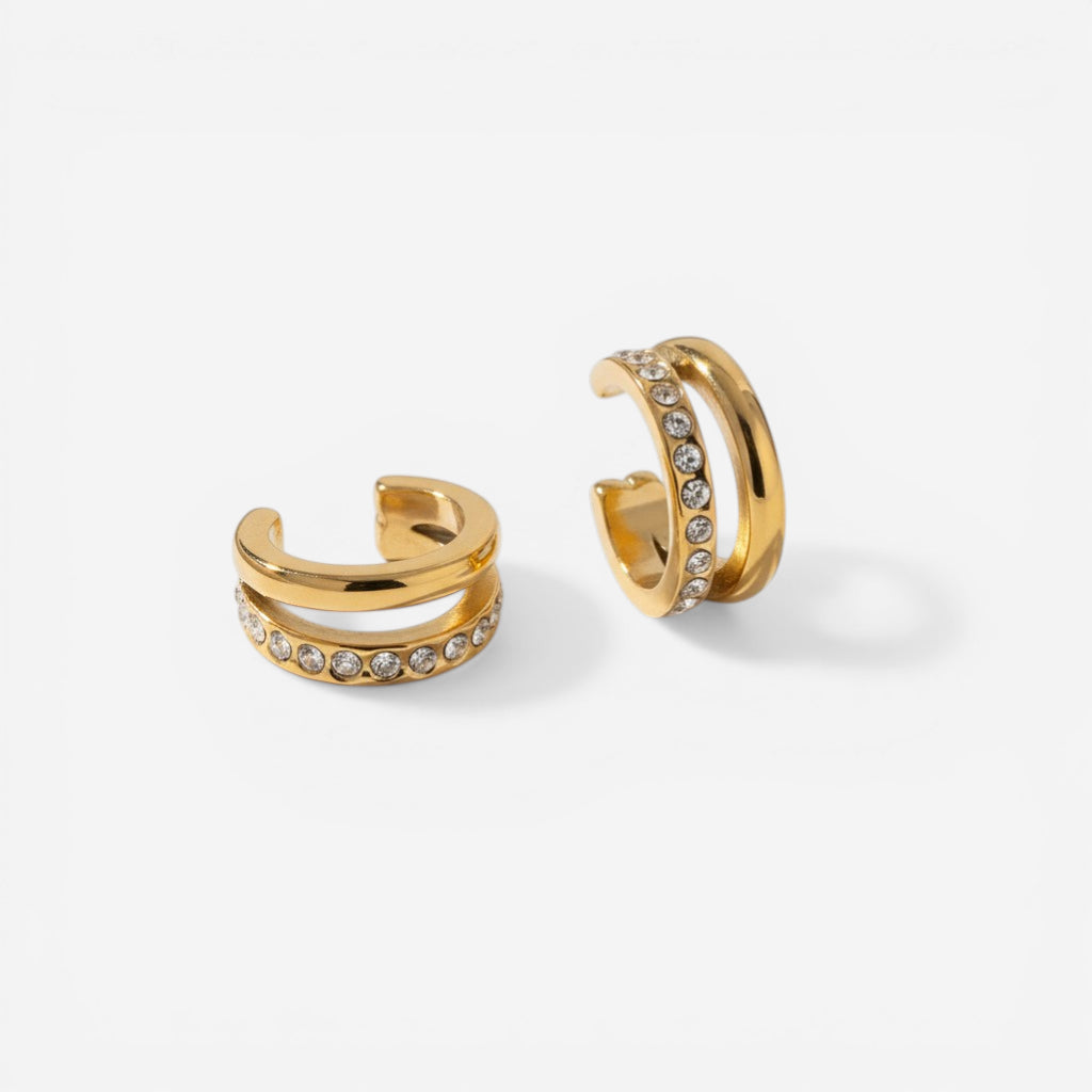 Adjustable C-shape gold ear cuffs with cubic zirconia details.