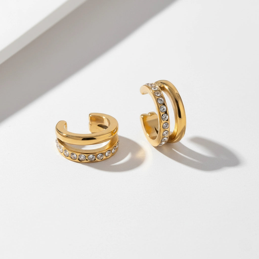 Adjustable C-shape gold ear cuffs with cubic zirconia details.