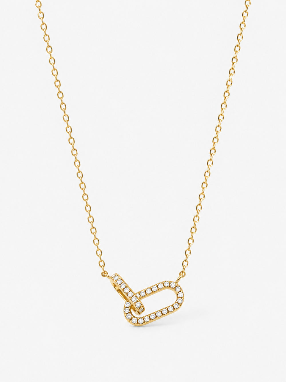 Sculpted Ribbon Heart Necklace in polished gold with clear zircon accents on a white background