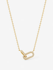 Sculpted Ribbon Heart Necklace in polished gold with clear zircon accents on a white background