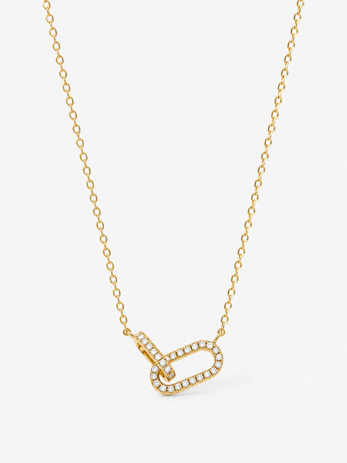 Sculpted Ribbon Heart Necklace in polished gold with clear zircon accents on a white background