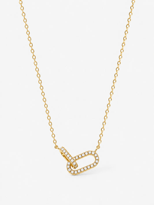 Sculpted Ribbon Heart Necklace in polished gold with clear zircon accents on a white background