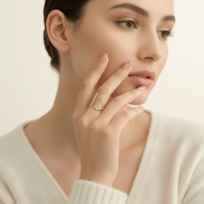 Close-up lifestyle image of a model's hands, showcasing the detailed craftsmanship and comfortable, open fit of the all-gold Seraphina angel wing ring.