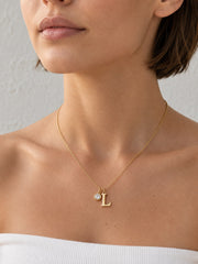 Model wearing the Signature Initial Zircon Necklace for an everyday gold jewelry look