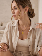 Two-tone sculptural stud earrings styled in everyday lifestyle photo