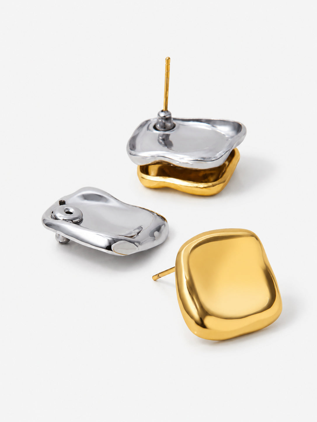 Two-tone sculptural stud earrings with gold front and silver side detail