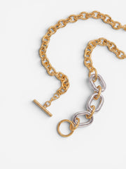 Close-up detail of gold and silver chunky chain necklace with clasp