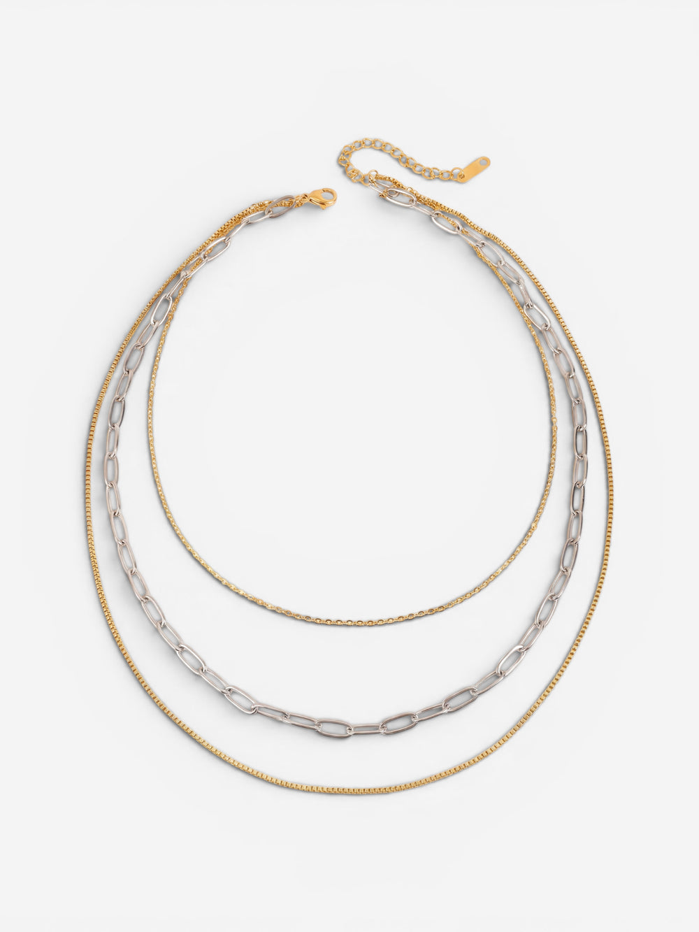 Gold and silver two-tone mixed chain layered necklace on white background