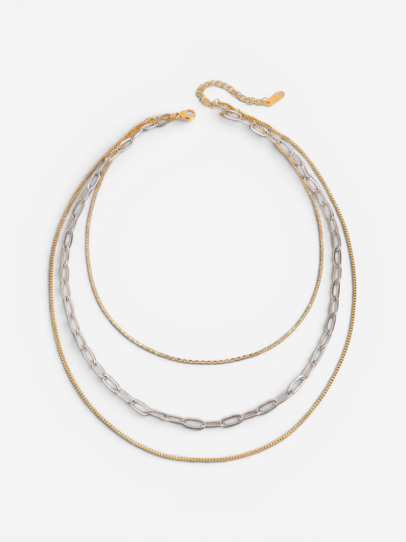 Gold and silver two-tone mixed chain layered necklace on white background