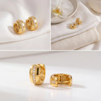 Aesthetic product photography of Vega crystal stripe hoops on white stone display.