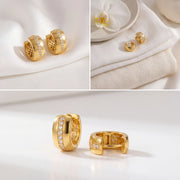 Aesthetic product photography of Vega crystal stripe hoops on white stone display.