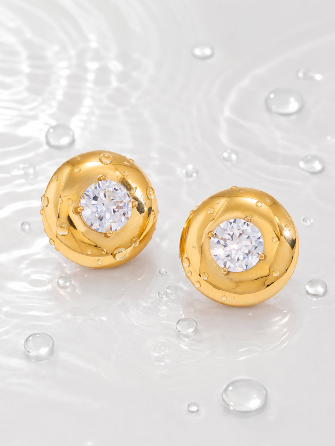 Vesta Bold Dome Studs with polished gold domes and round cubic zirconia centers