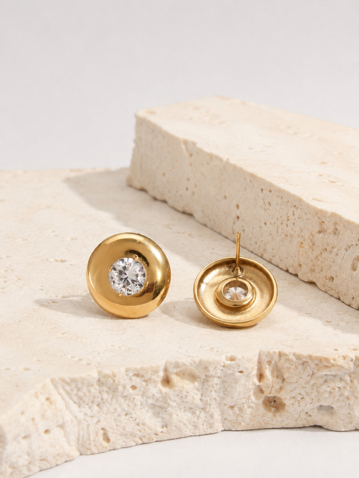 Close-up of Vesta Bold Dome Studs showing rounded gold domes and cubic zirconia centers