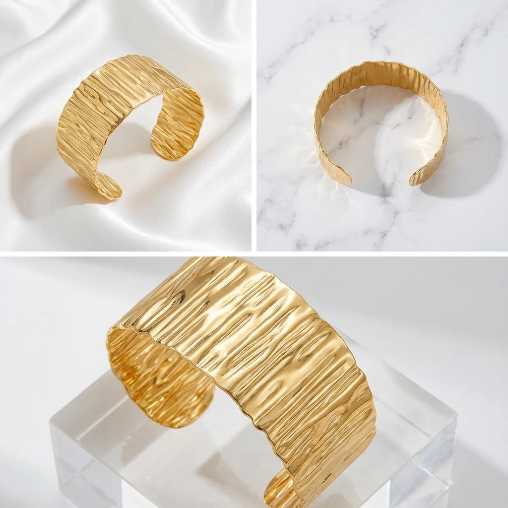 Aesthetic product photography collage of wide gold statement cuff on marble and silk.