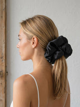 Model wearing Form Silk Pillow Scrunchie in Onyx Black