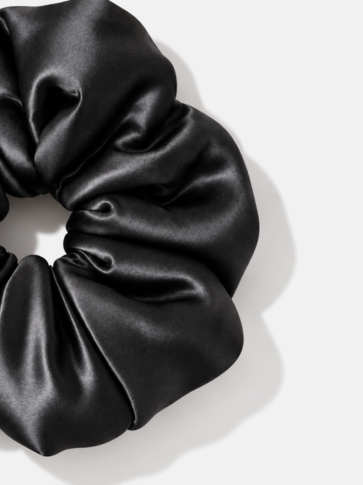 Close-up of Form Silk Pillow Scrunchie in Onyx Black