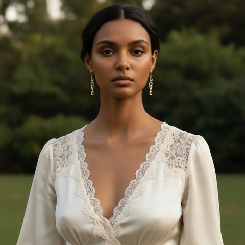 Full view of a model in an elegant white gown, where The Amor Earrings act as the perfect bold yet sophisticated accessory for a special occasion.