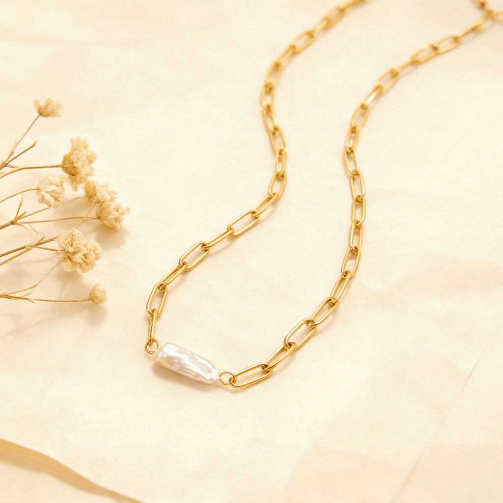 The Aphrodite baroque pearl necklace gently coiled, with the one-of-a-kind pearl at the center, styled with delicate dried flowers to emphasize its natural beauty.
