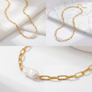 Aesthetic product photography of organic baroque pearl necklace on white marble background.