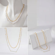 Aesthetic product display of layered gold and white tube bead necklace on jewelry stand.