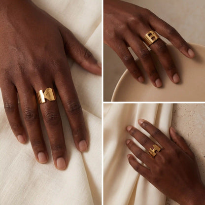Model with dark skin wearing gold initial signet ring personalized gift for her.