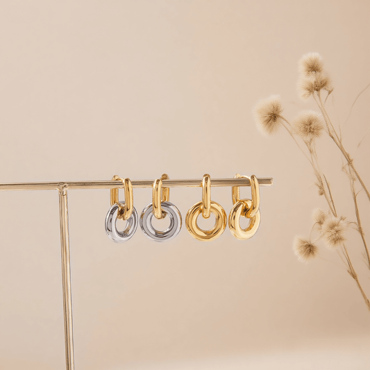 Chunky Twist Knot Hoop Earrings in 18K Gold Plated Brass, isolated on a white gold background.