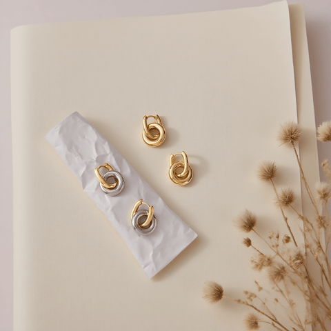 Close-up detail of the 3D twist knot and luxurious gold plating on Luminova's hoop earrings.