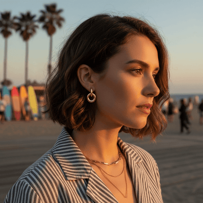 Female model confidently wearing the bold Chunky Twist Knot Hoop Earrings, looking at camera.