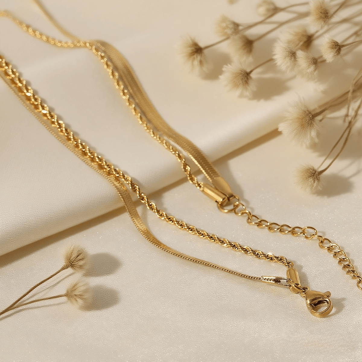 Classic Layered Chain Necklace — dual gold chains (herringbone + rope) on model neckline, elegant layering jewelry piece.