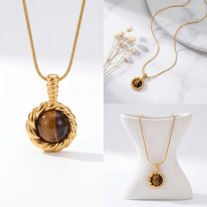 Aesthetic product photography of gold courage stone necklace on jewelry stand.