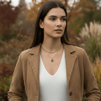 A close-up of one person's hands fastening The Courage Stone Necklace around another person's neck. The image captures a tender, supportive moment, positioning the necklace as the perfect gift of encouragement