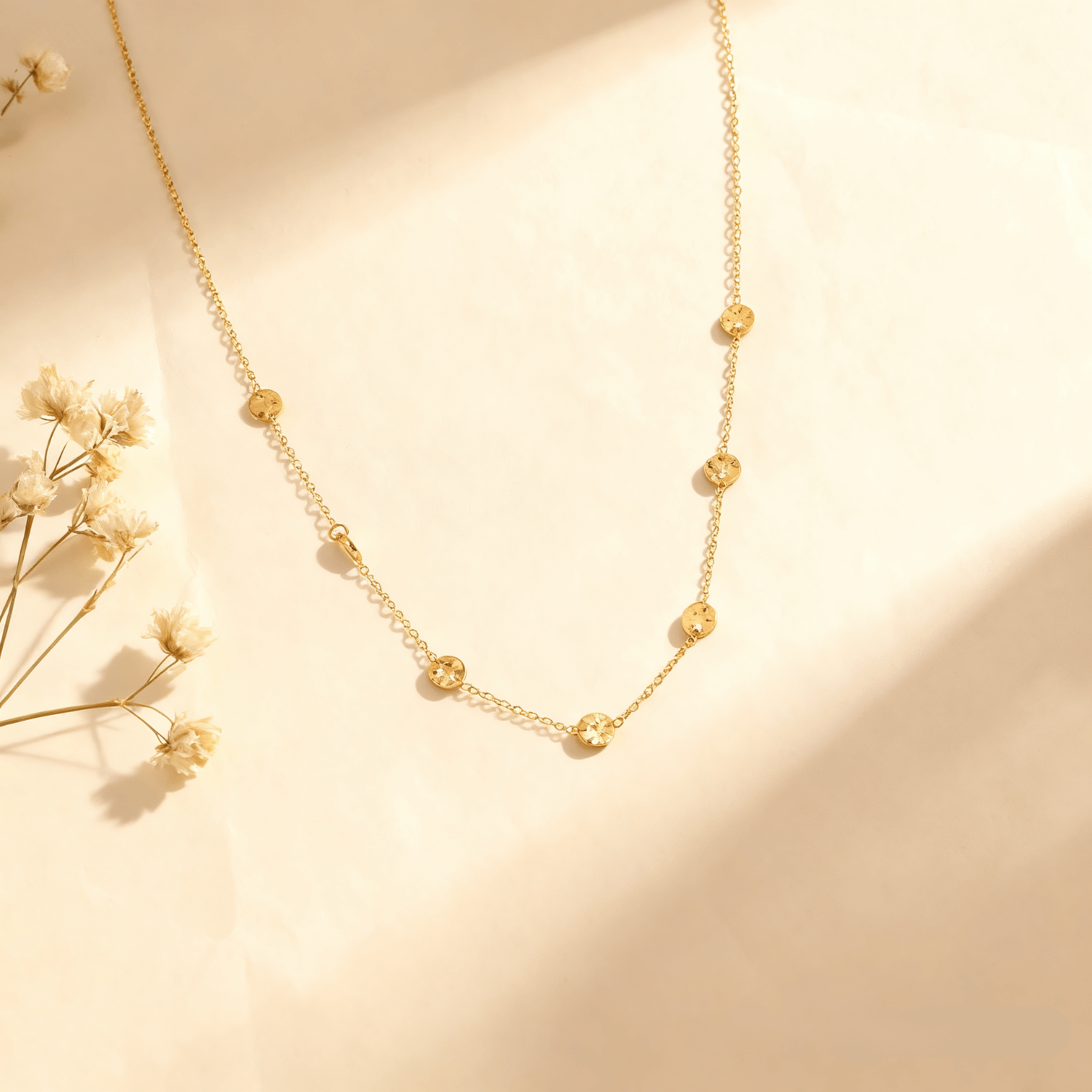 Luminova Dainty Bezel Station Gold Necklace with an empty setting, isolated on a white gold background.