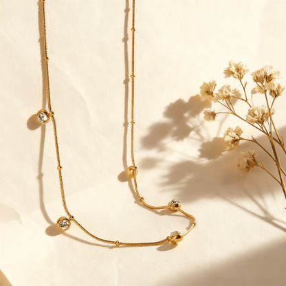 Luminova Dainty Gold Drop Necklace with a teardrop pendant, isolated on a white background.