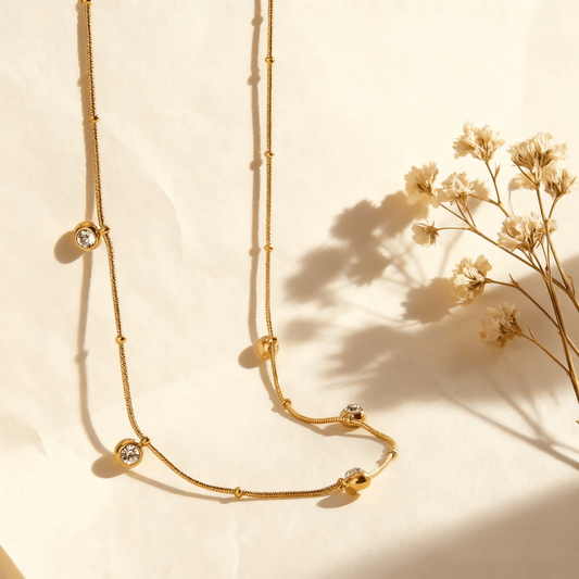 Luminova Dainty Gold Drop Necklace with a teardrop pendant, isolated on a white background.