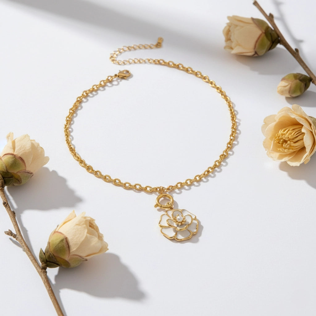 The Fleur Pendant laid out in a circle and styled with dried white flowers, evoking a sense of timeless, romantic charm.