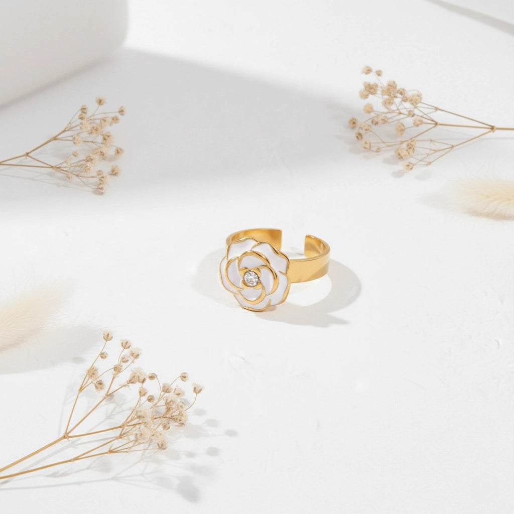 An artistic flat lay of The Fleur Ring styled with delicate dried flowers, emphasizing its timeless, Parisian-chic aesthetic.