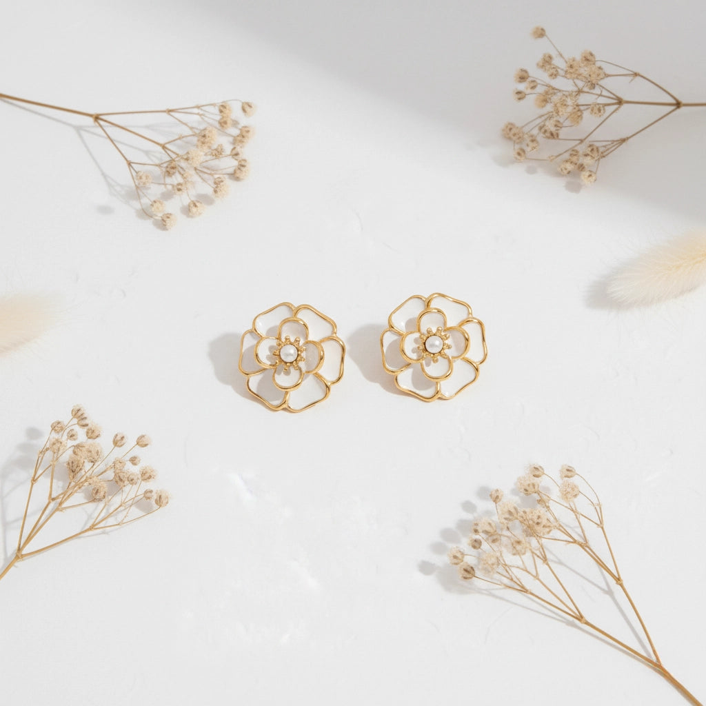 An artistic flat lay of The Fleur Studs styled with delicate dried flowers, emphasizing their romantic, Parisian-chic aesthetic.