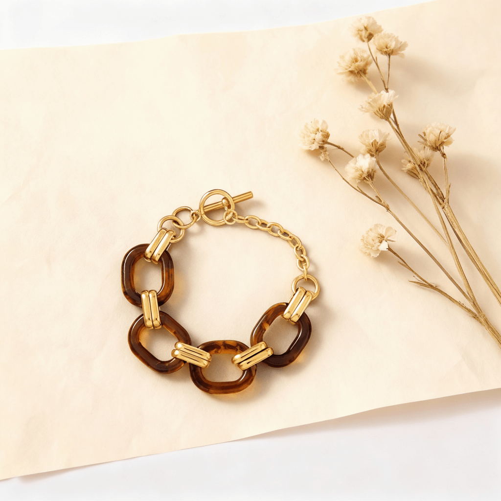 An artistic shot of the Florence tortoiseshell bracelet coiled in a circle and styled with delicate dried flowers to highlight its vintage-inspired aesthetic.