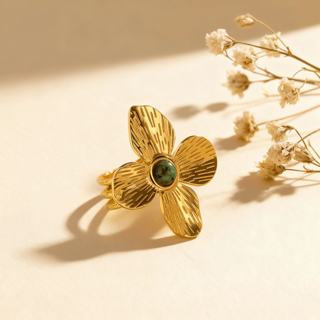 The Gaia Ring placed on a rustic wooden surface in direct sunlight. The bold, floral design casts a dramatic shadow, emphasizing its sculptural, three-dimensional form.