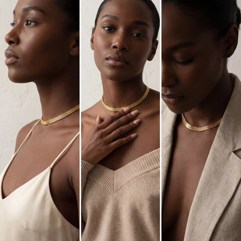 Model with dark skin wearing gold mesh necklace styled with blazer and top.