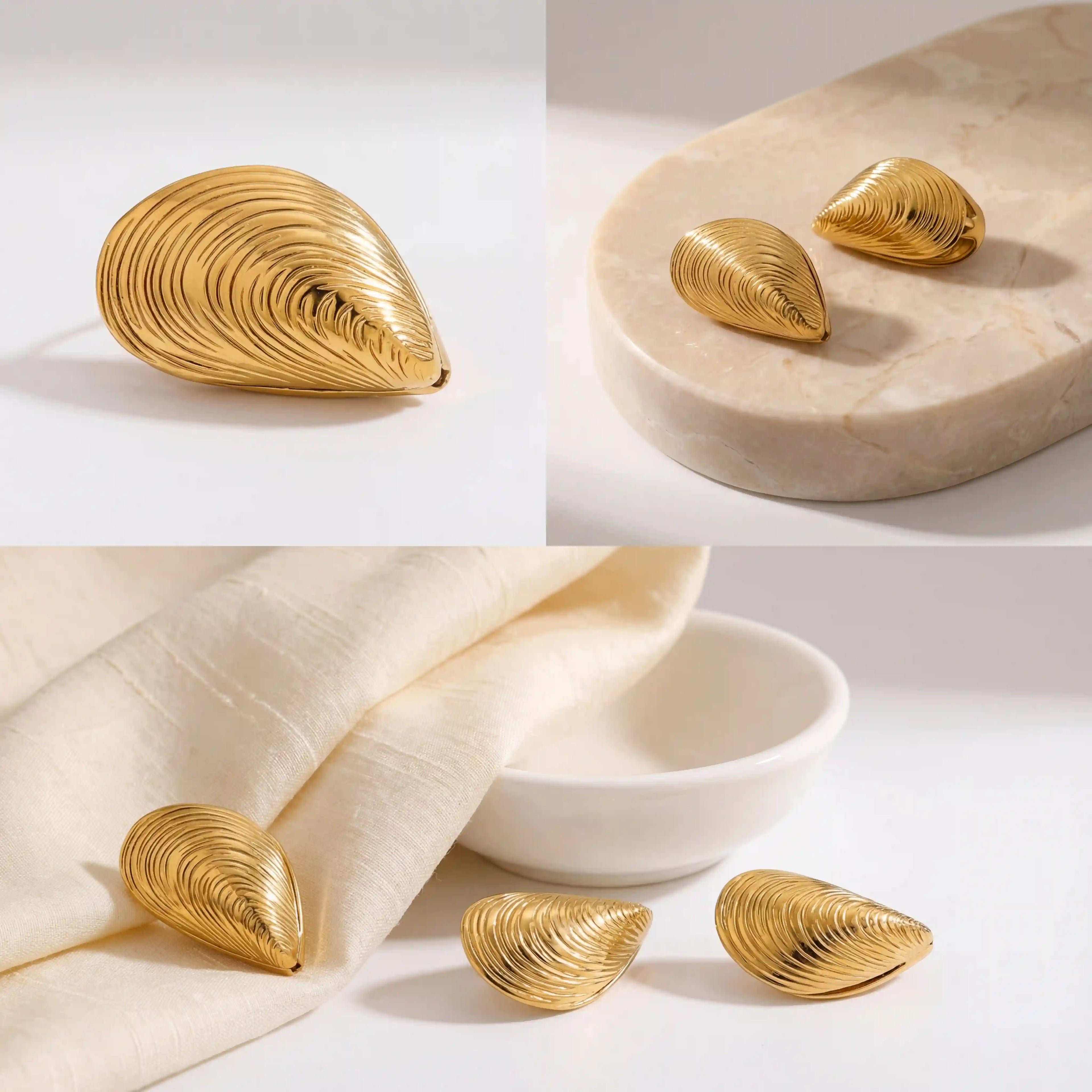 Aesthetic flat lay of gold shell earrings on beige stone and linen background.