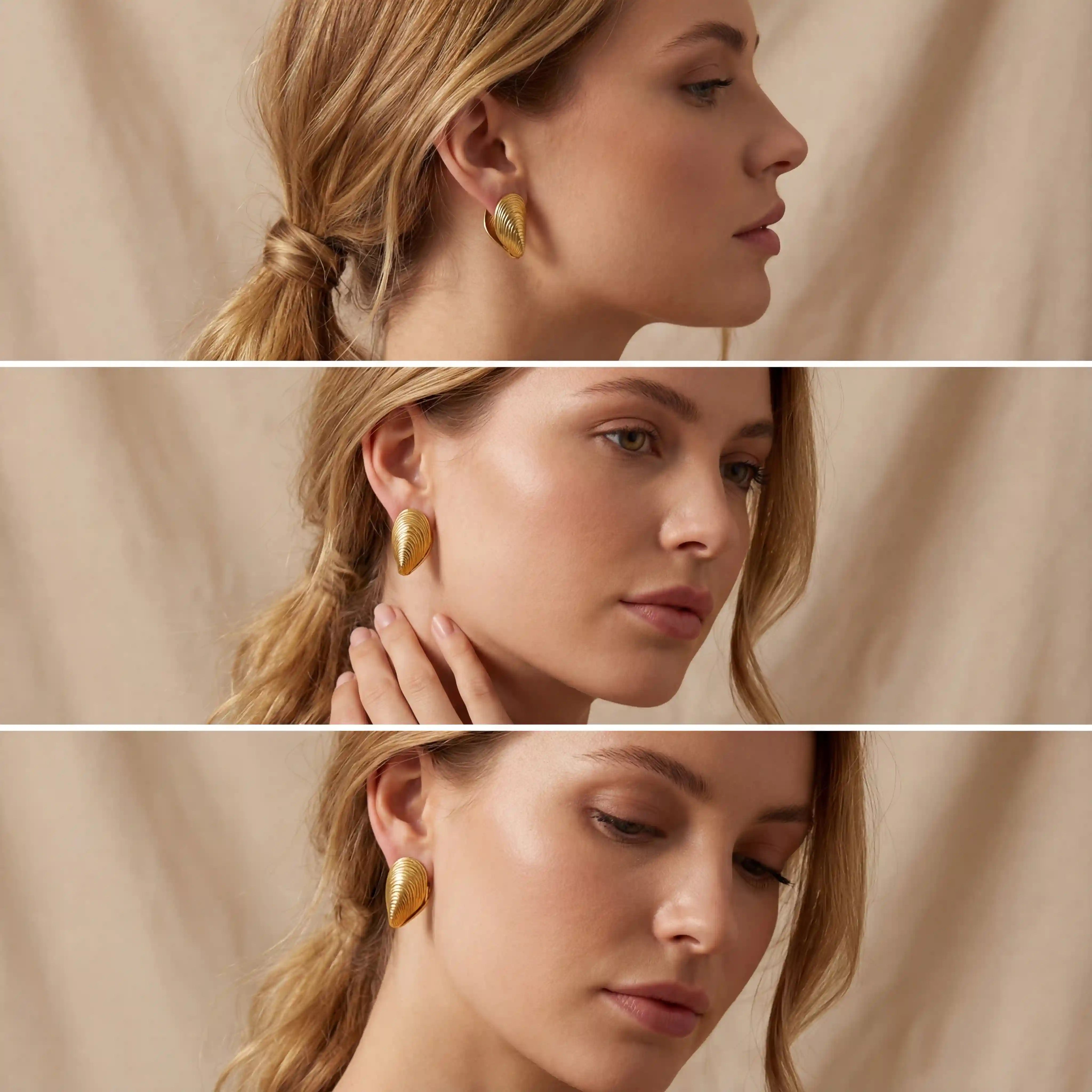 Blonde model styling gold mussel shell earrings for summer look.