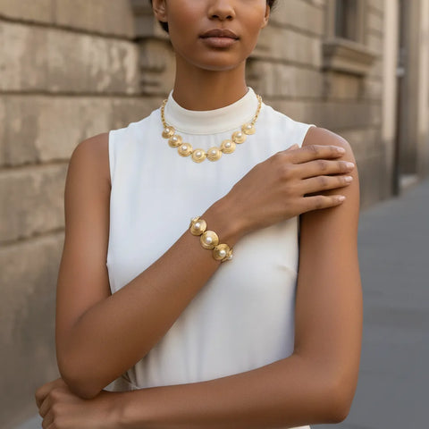 A model showcasing the complete royal set, wearing both The Hera Bracelet and the matching Hera Necklace for a powerful, coordinated statement.