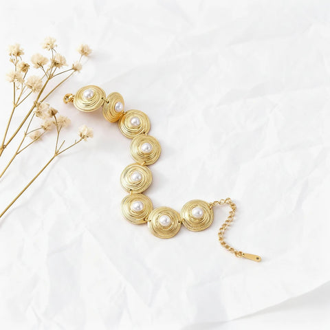 The full length of The Hera Bracelet laid out on a piece of white crumpled fabric, showing the adjustable chain and secure lobster clasp.